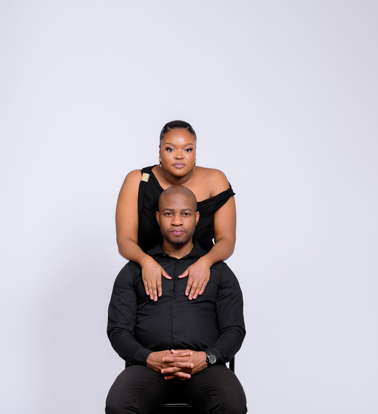 Nancy and Tebogo in elegant black attire, seated together